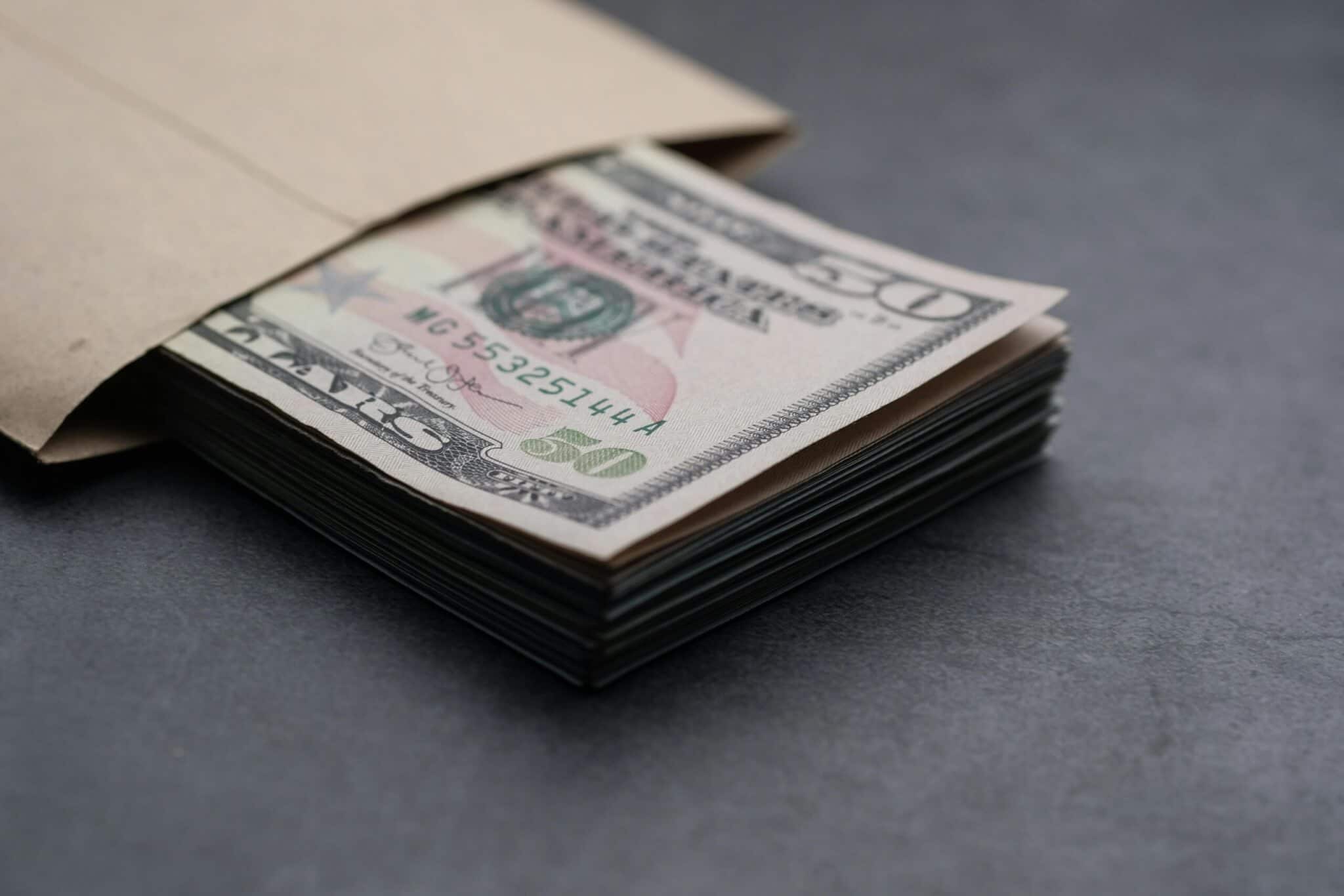 Stack of $50 bills in an envelope