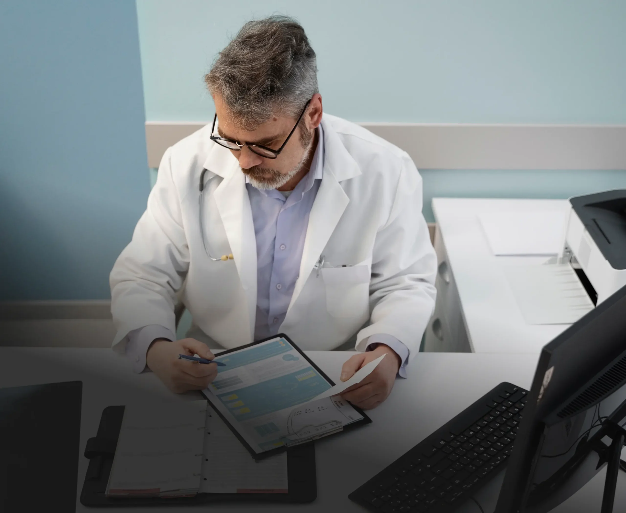 Veterinarian reviewing records at his desk