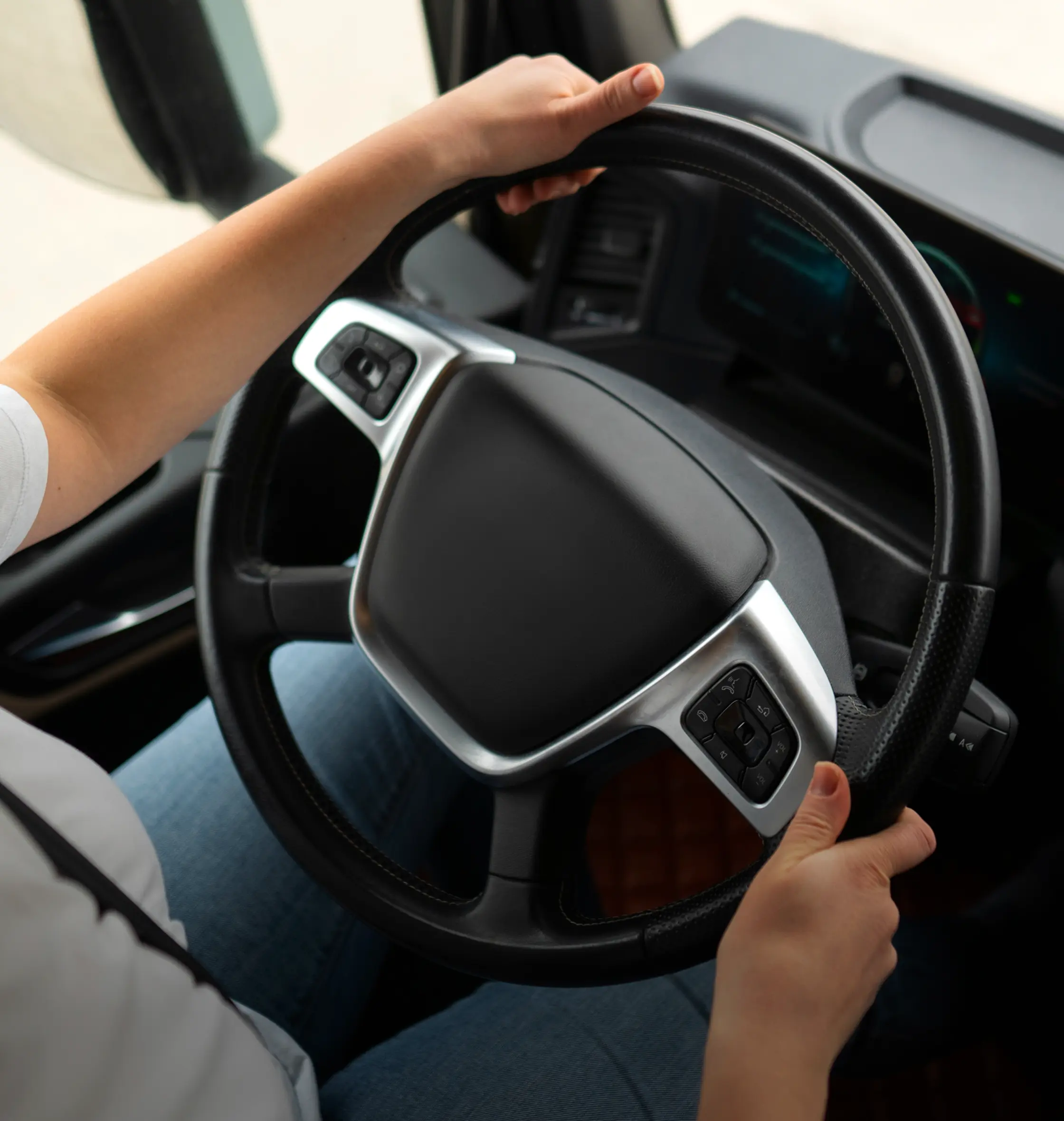Hands on the steering wheel of a truck