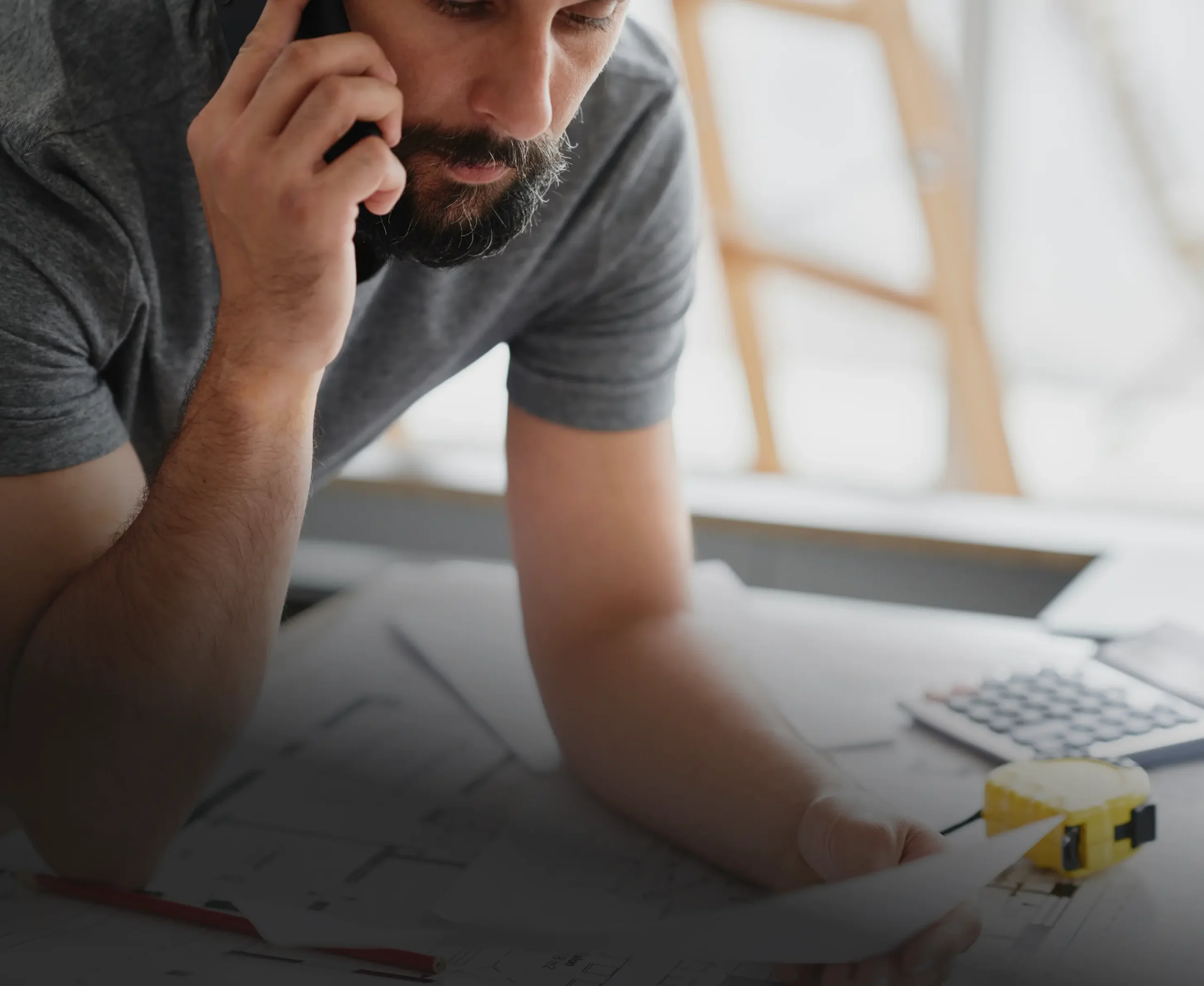 HVAC business owner on the phone while reviewing paperwork