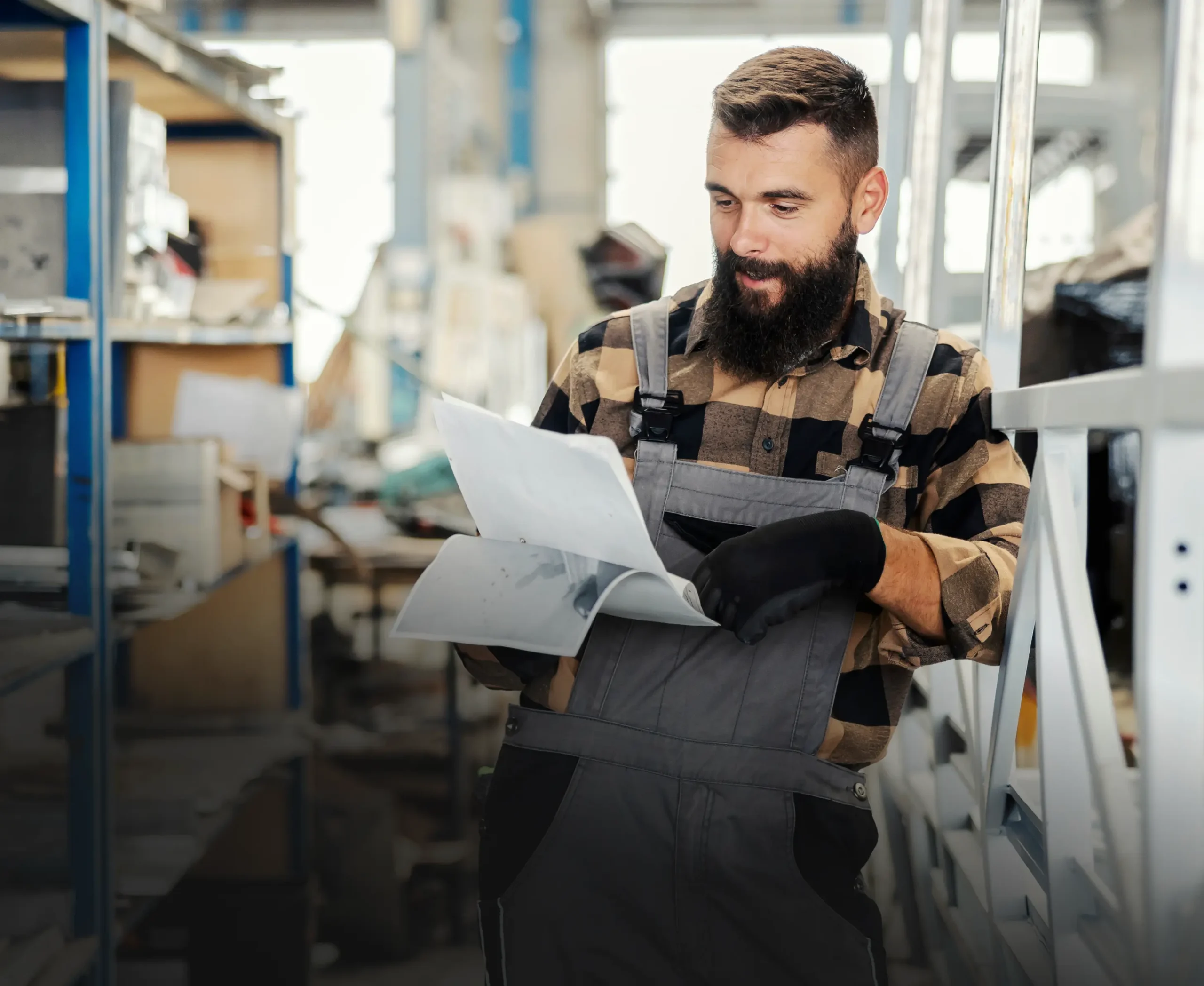 Manufacturing worker reading paperwork on the factory floor