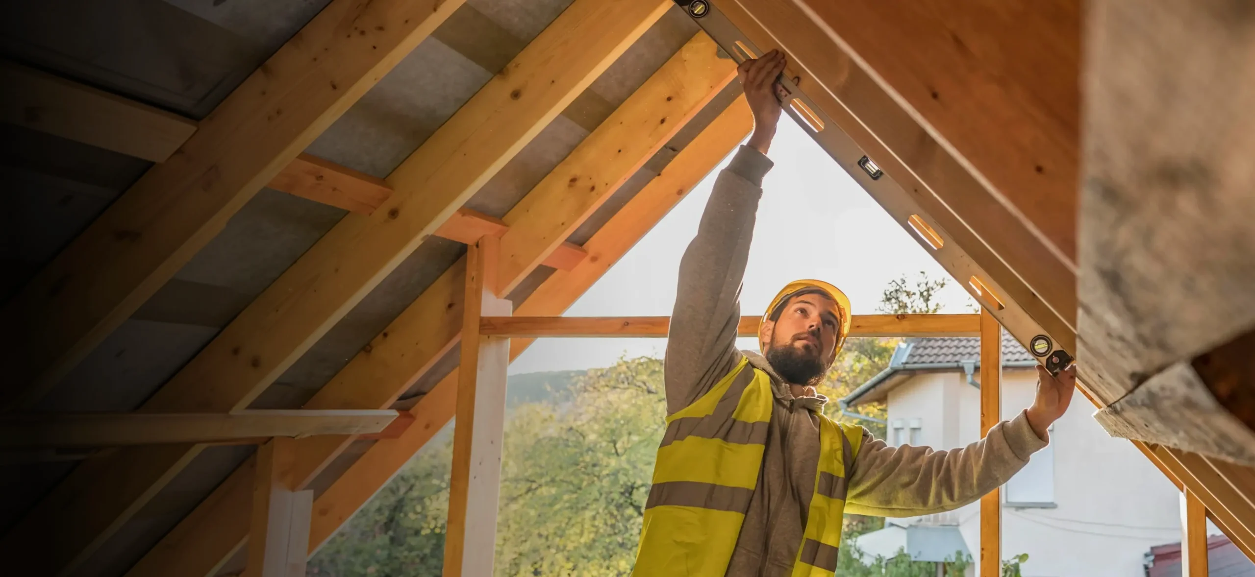 Roofer measuring the timber frame of a new roof