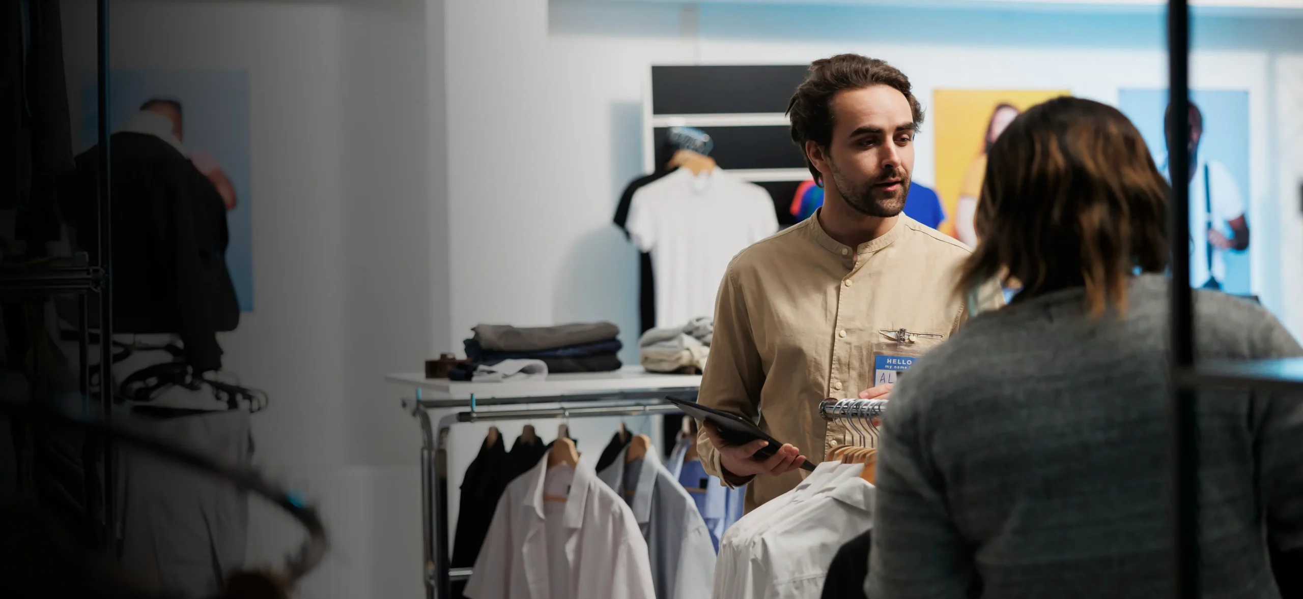 Clothing store owner helping a customer