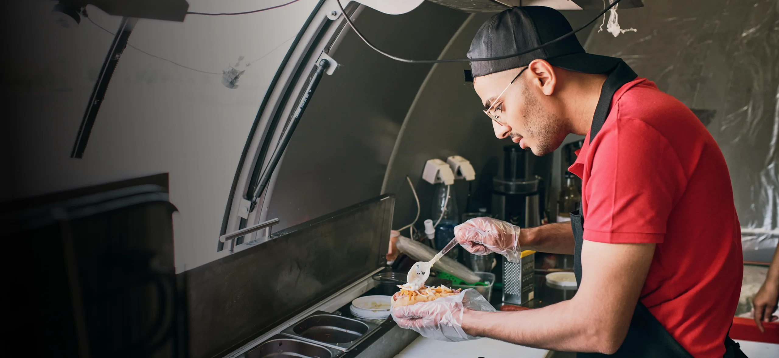 Food truck cook preparing an order