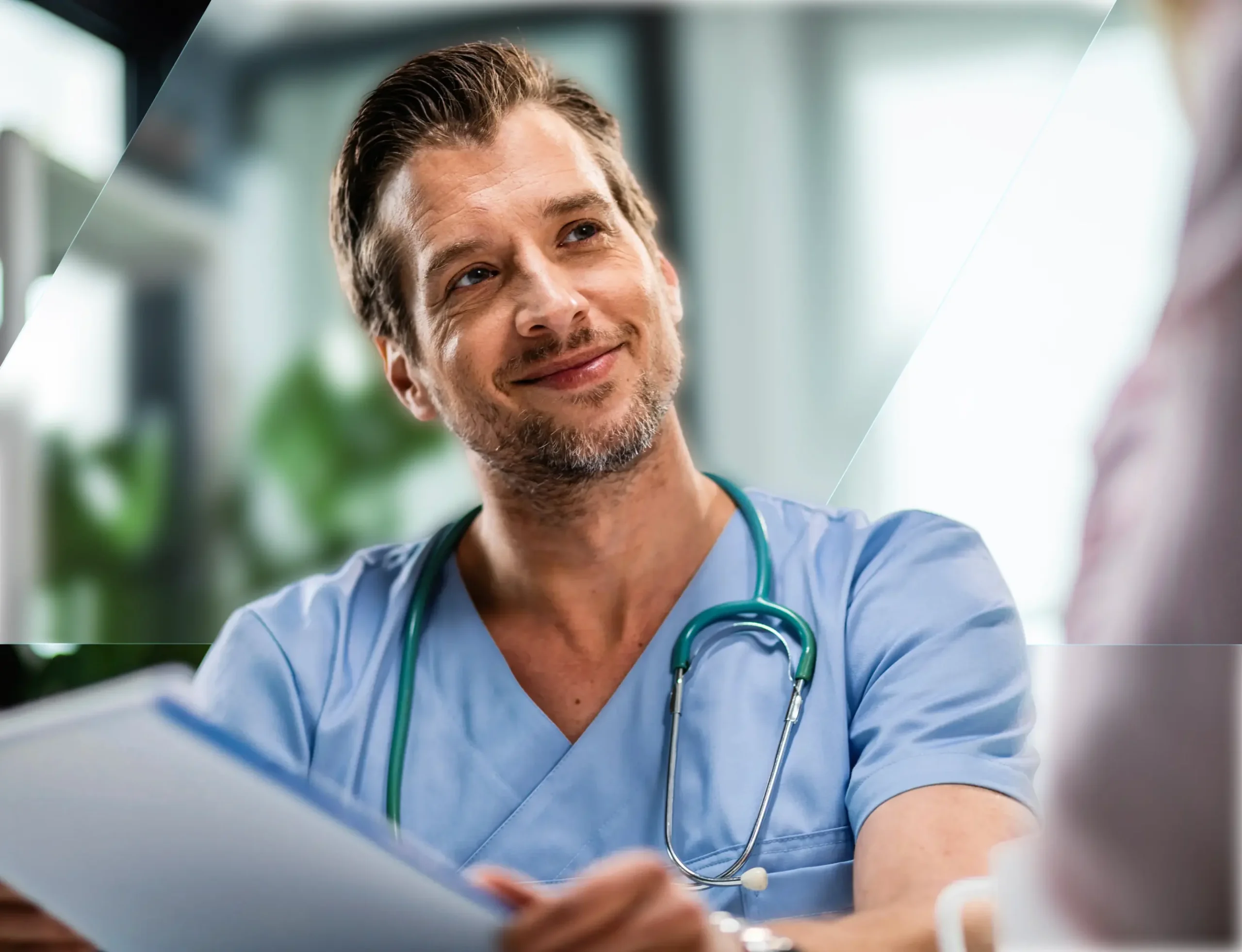 Doctor in scrubs talking with a patient