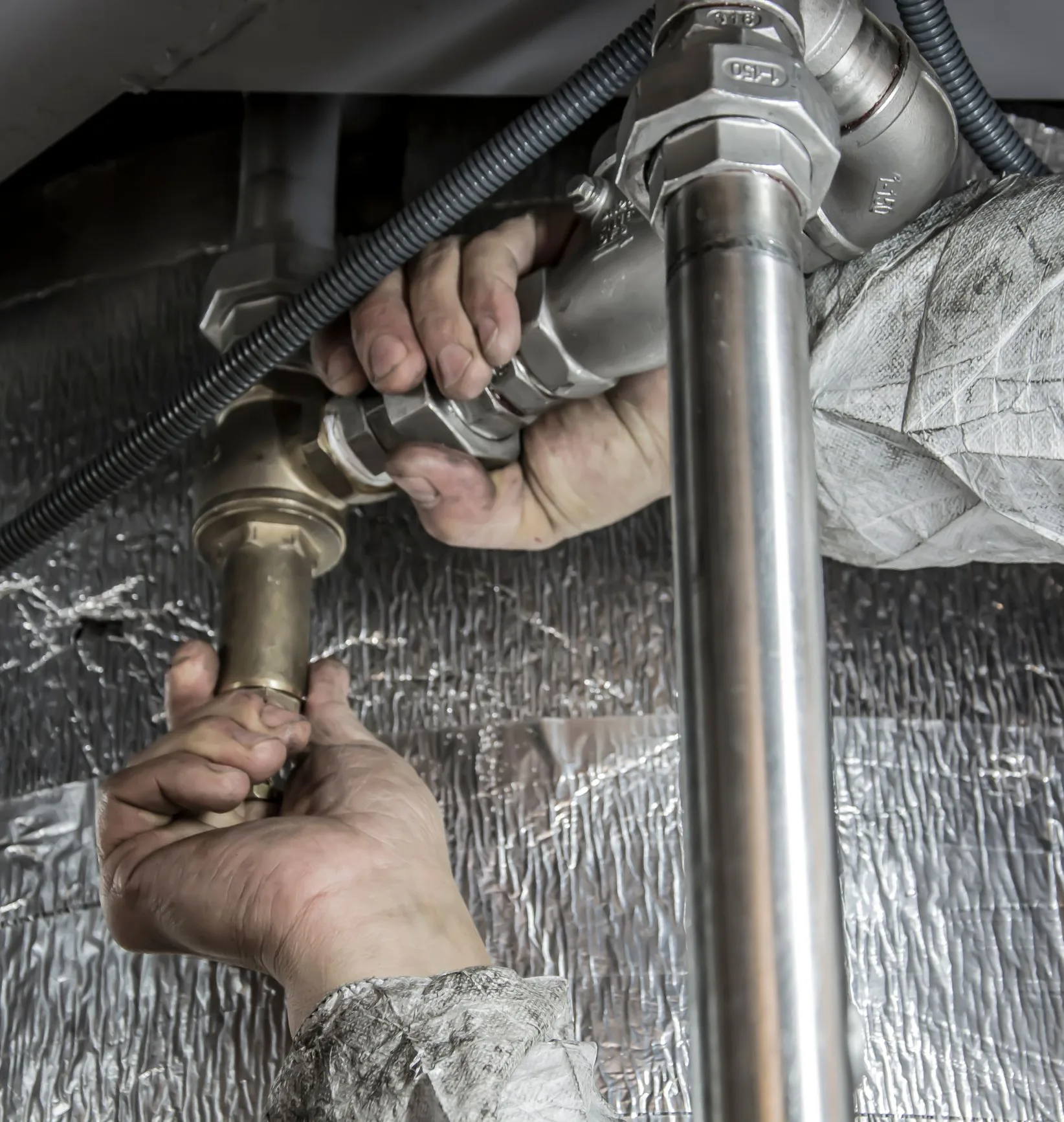 Plumber fitting a steel pipe connection