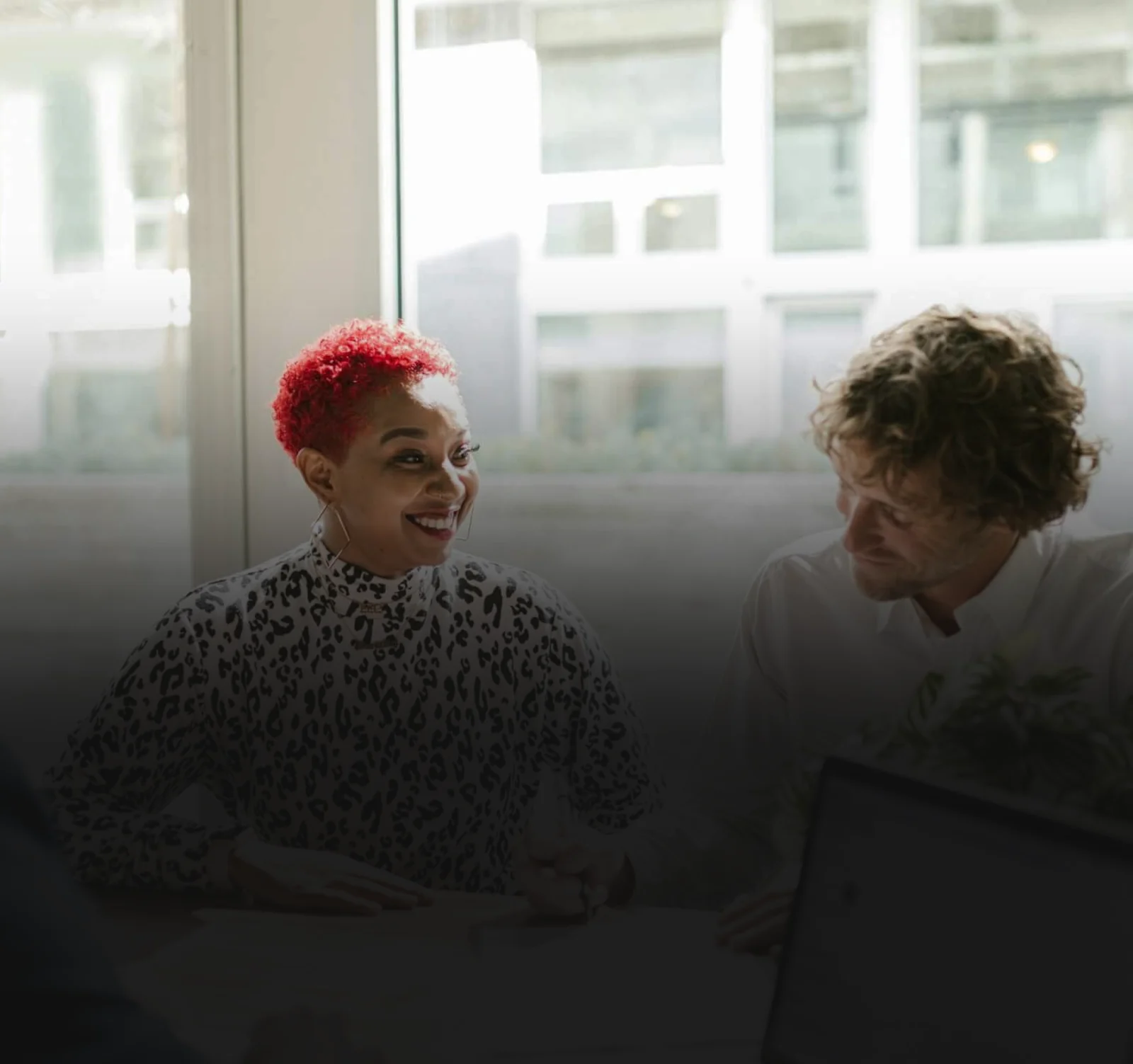Two business owners going over financing options at a table