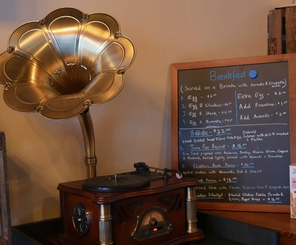 Cafe corner with a gramophone and a breakfast menu chalkboard