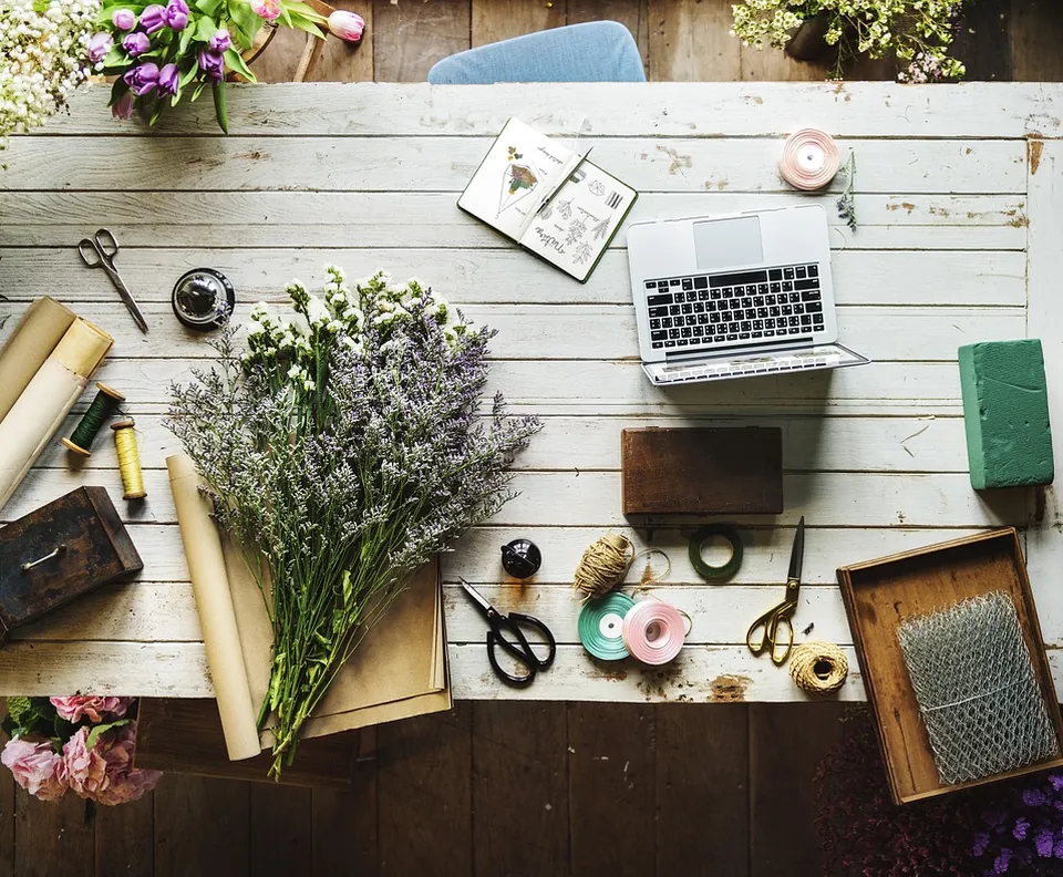 Home workspace with flowers and a laptop