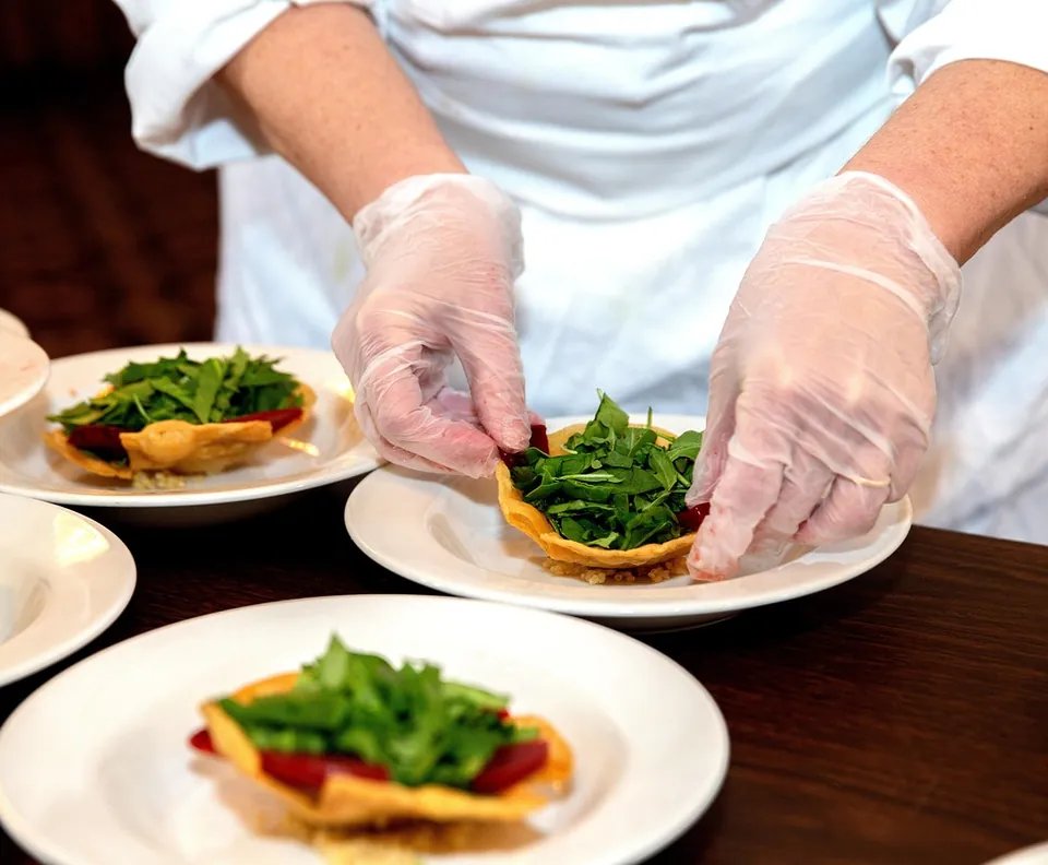 Chef plating dishes in a restaurant kitchen