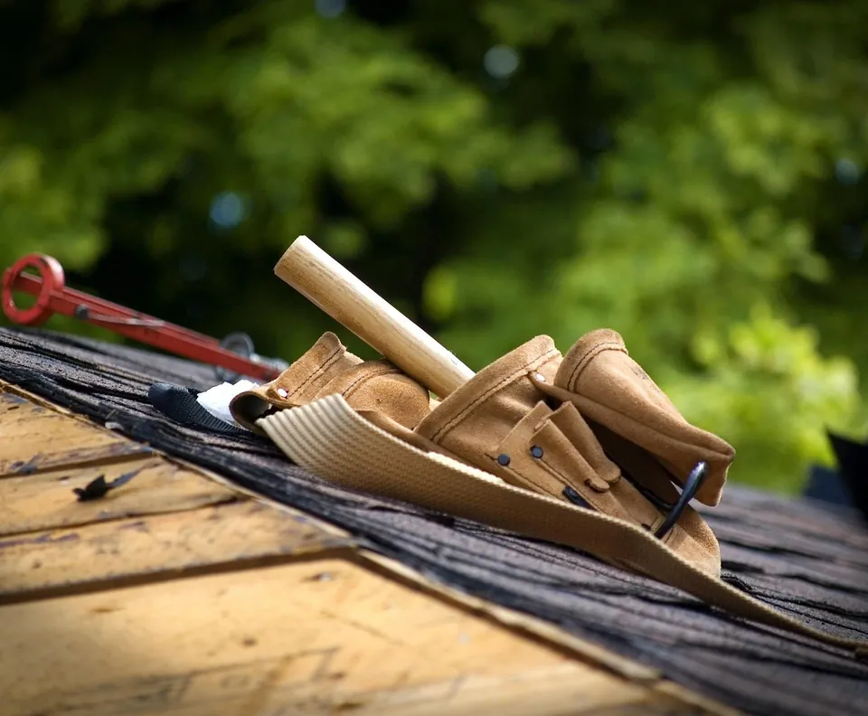 Roofer tool belt on new shingles