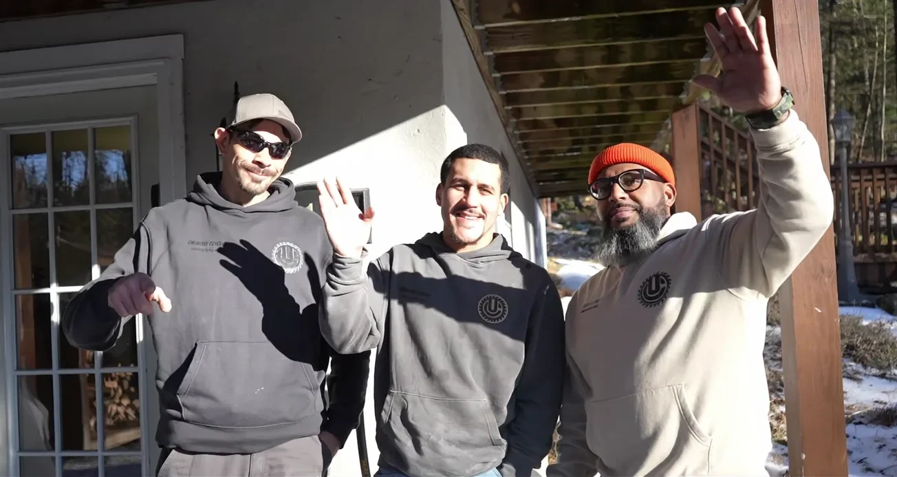 Omar Garcia and the Unlimited Concept crew waving outside a job site