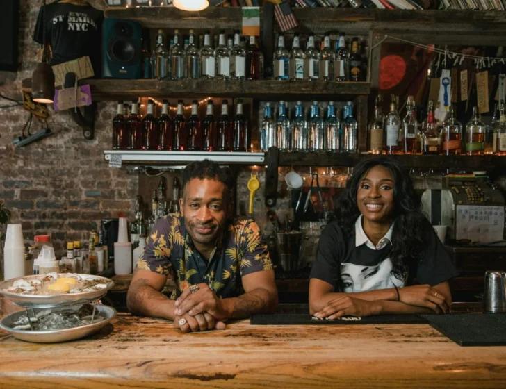Two restaurant owners behind their bar counter