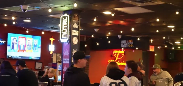 The DugOut BX bar full of customers in Yankees jerseys