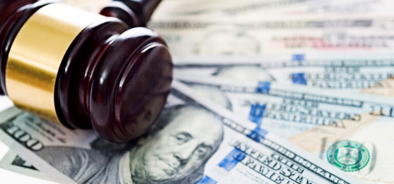 Gavel laying on top of us money