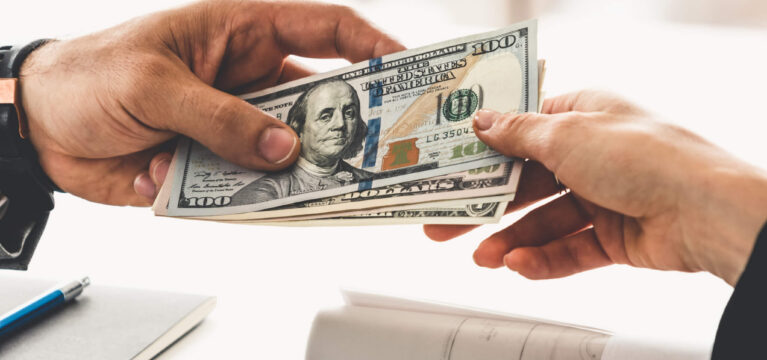 Businessman hand sending money to another business person