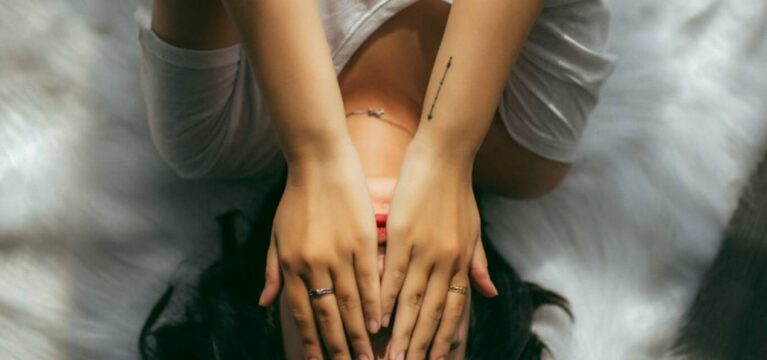Woman on bed looking stressed