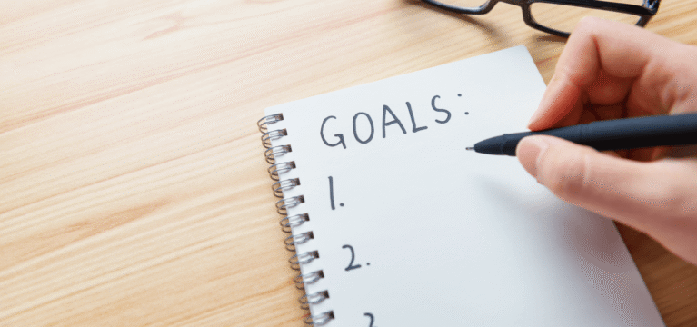 Writing goals on a piece of paper
