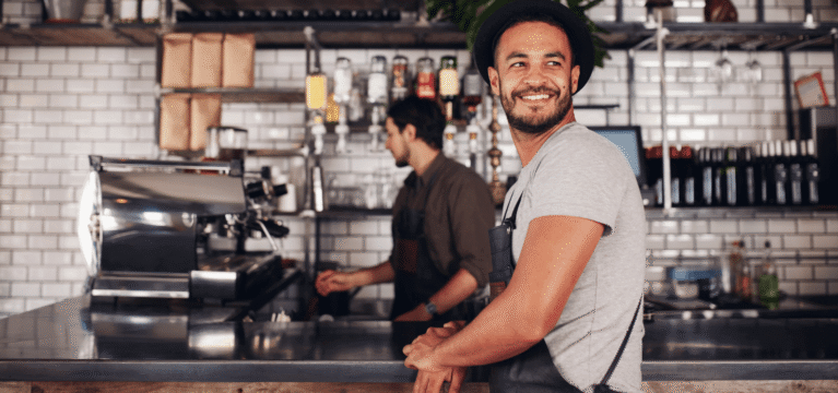 Handsome smiling waiter in a restaurant
