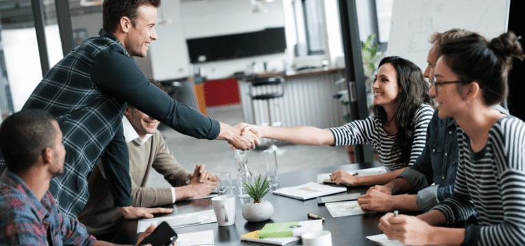 Smiling team onboarding a new employee