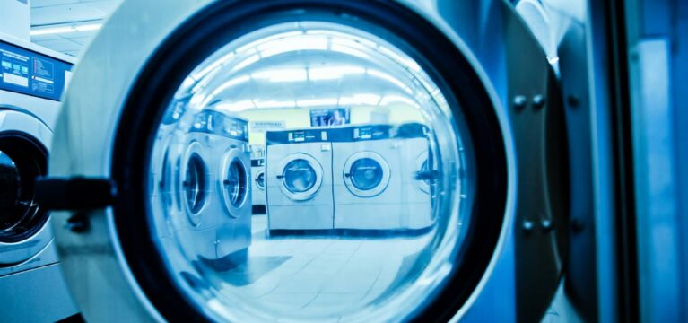 washers through the door of a washer at a laundromat