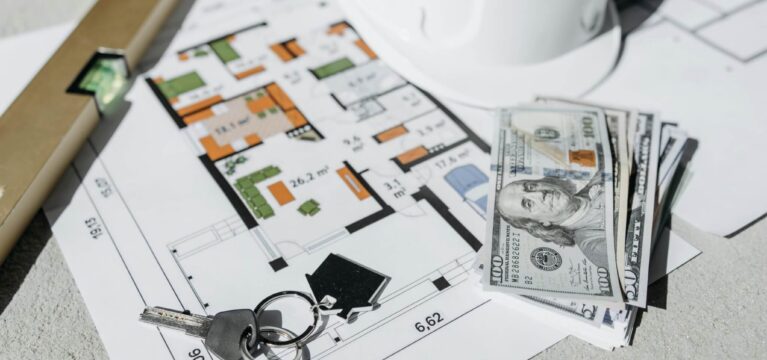 construction blueprints and cash on table